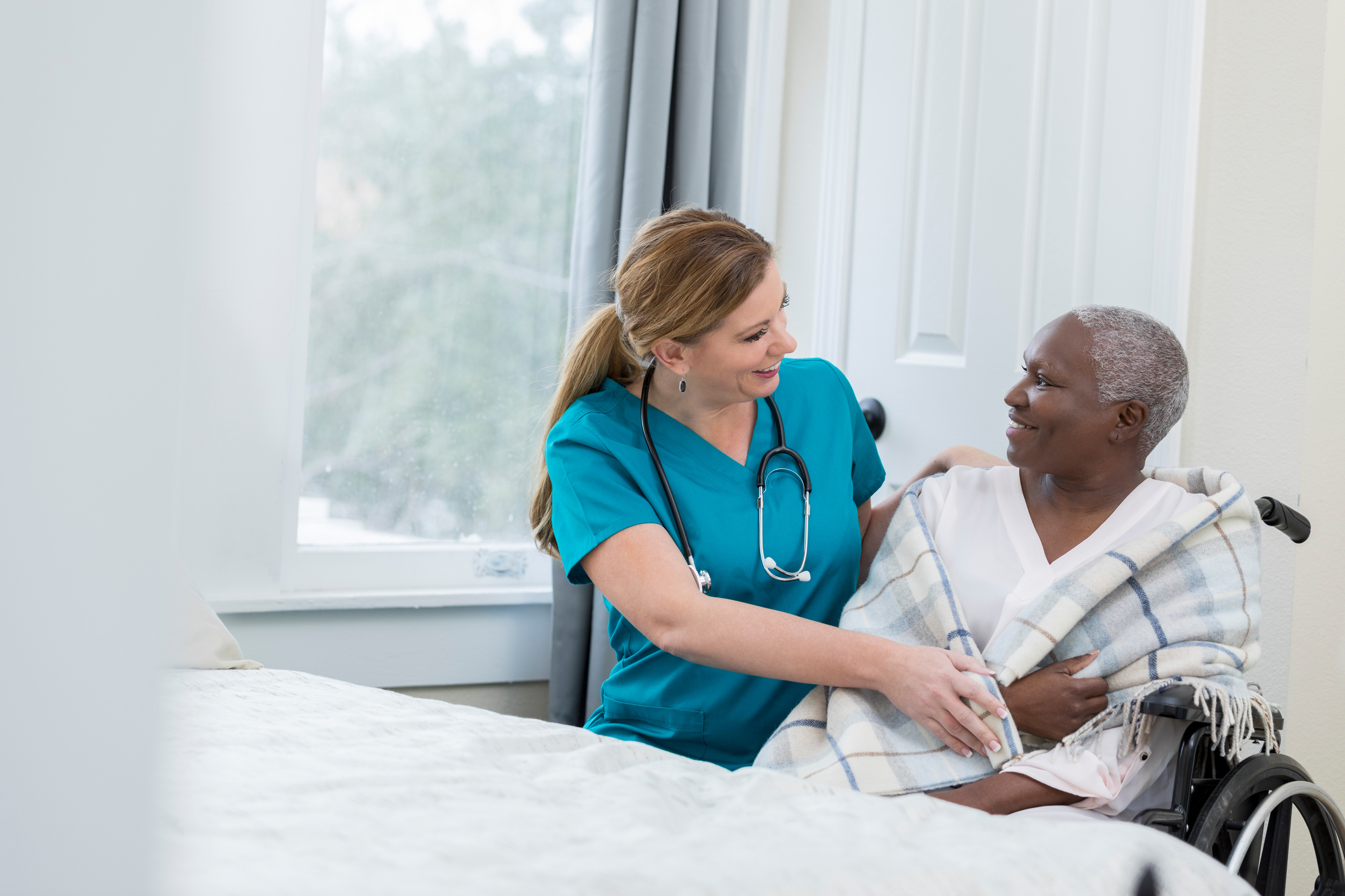 Nurse assists woman in nursing home